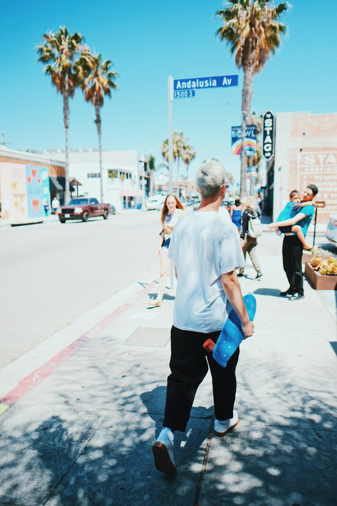 Young volunteer helping an elderly person carry groceries