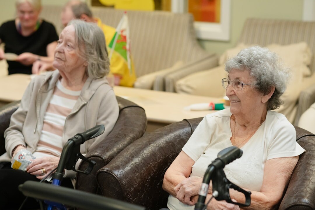 Group of smiling senior friends sitting together in a bright community room