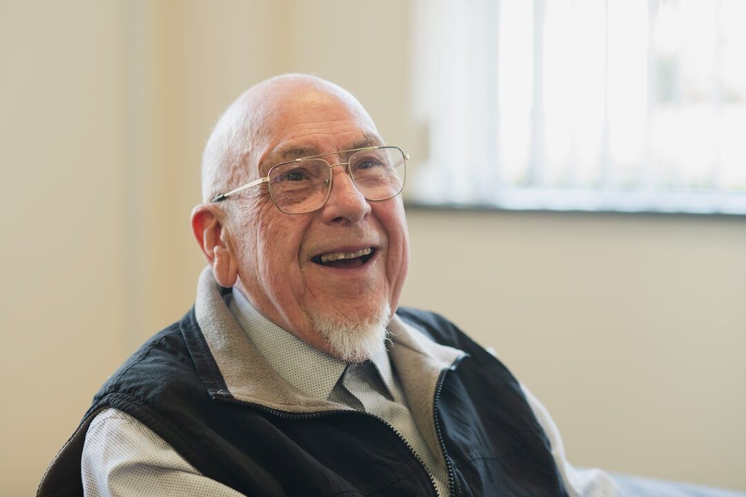 Portrait of a smiling elderly man with glasses